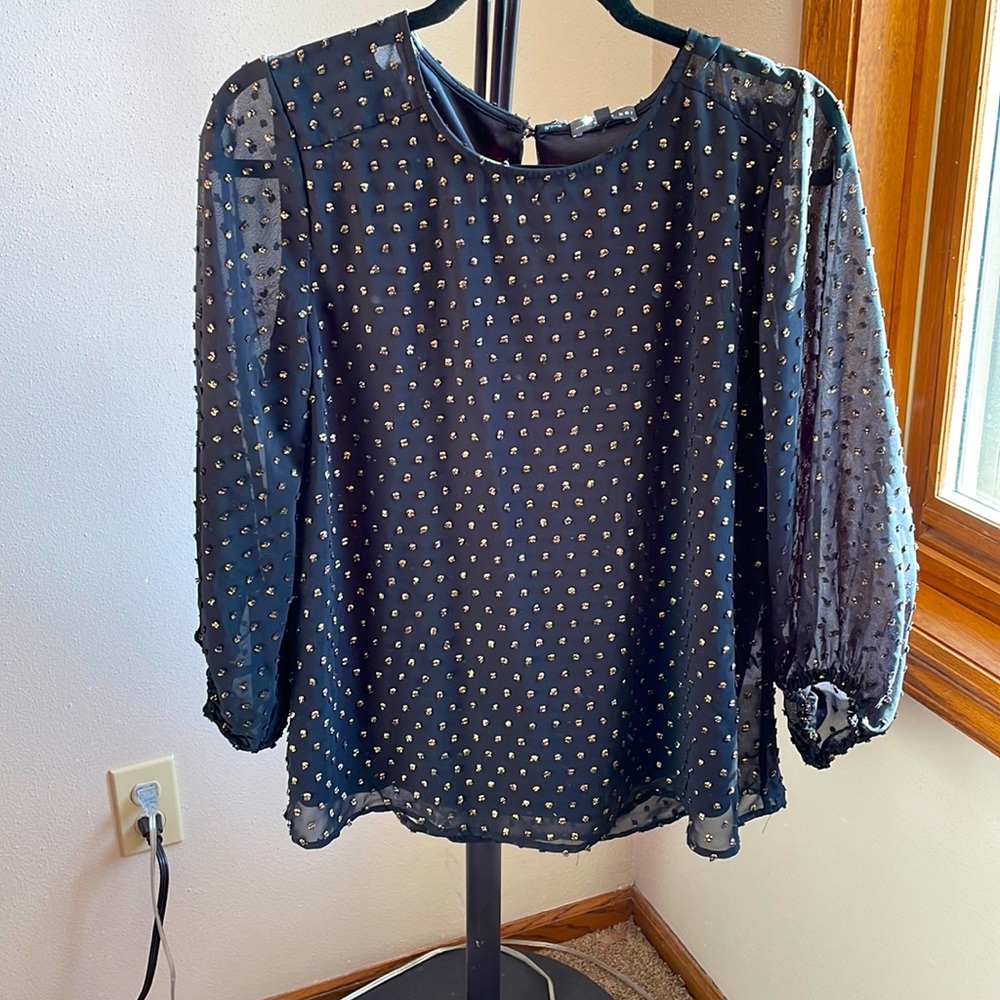 Black shirt with gold accents. Synched sleeves.